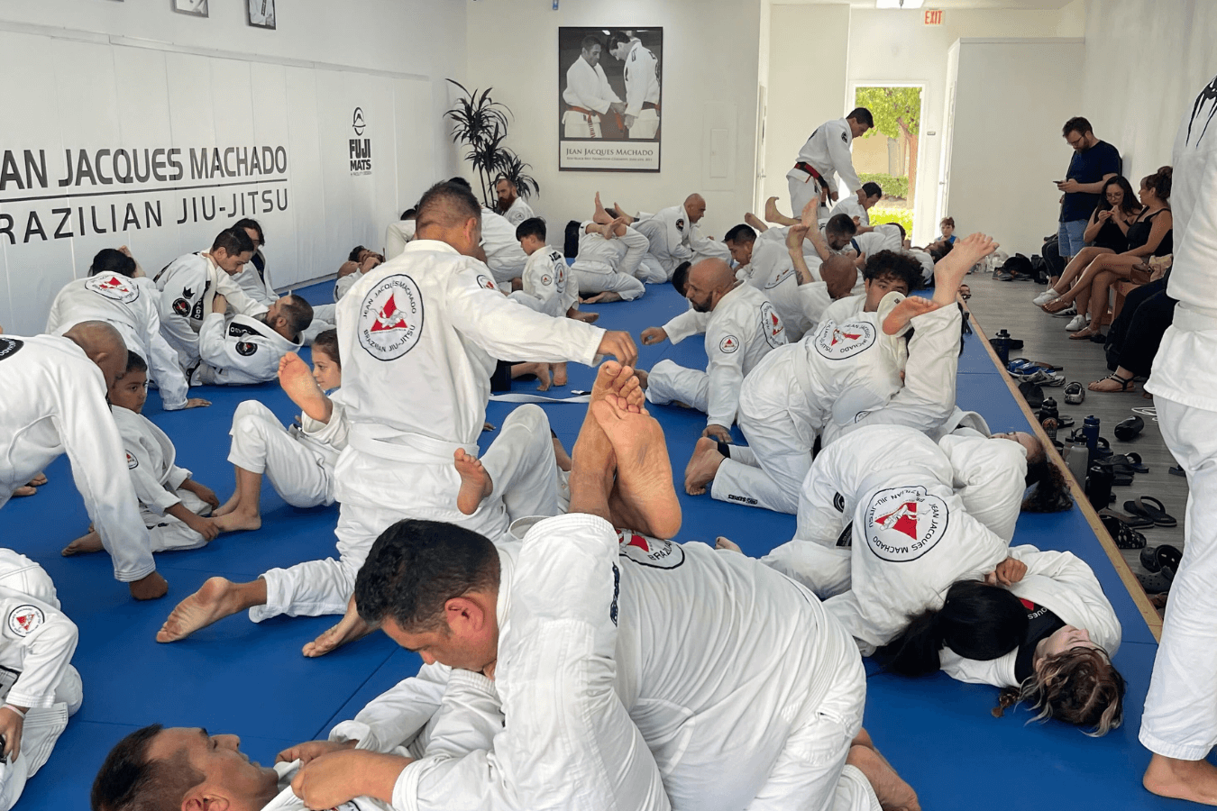 Adults practice Brazilian Jiu-Jitsu drills at Jean Jacques Machado Jiu-Jitsu Fresno in Fresno, CA to build confidence.