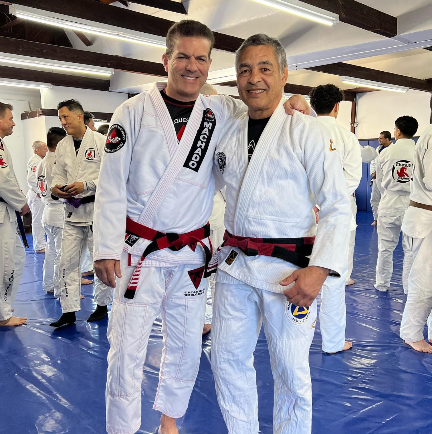 Adults practicing Brazilian Jiu-Jitsu at Jean Jacques Machado Fresno academy with expert.