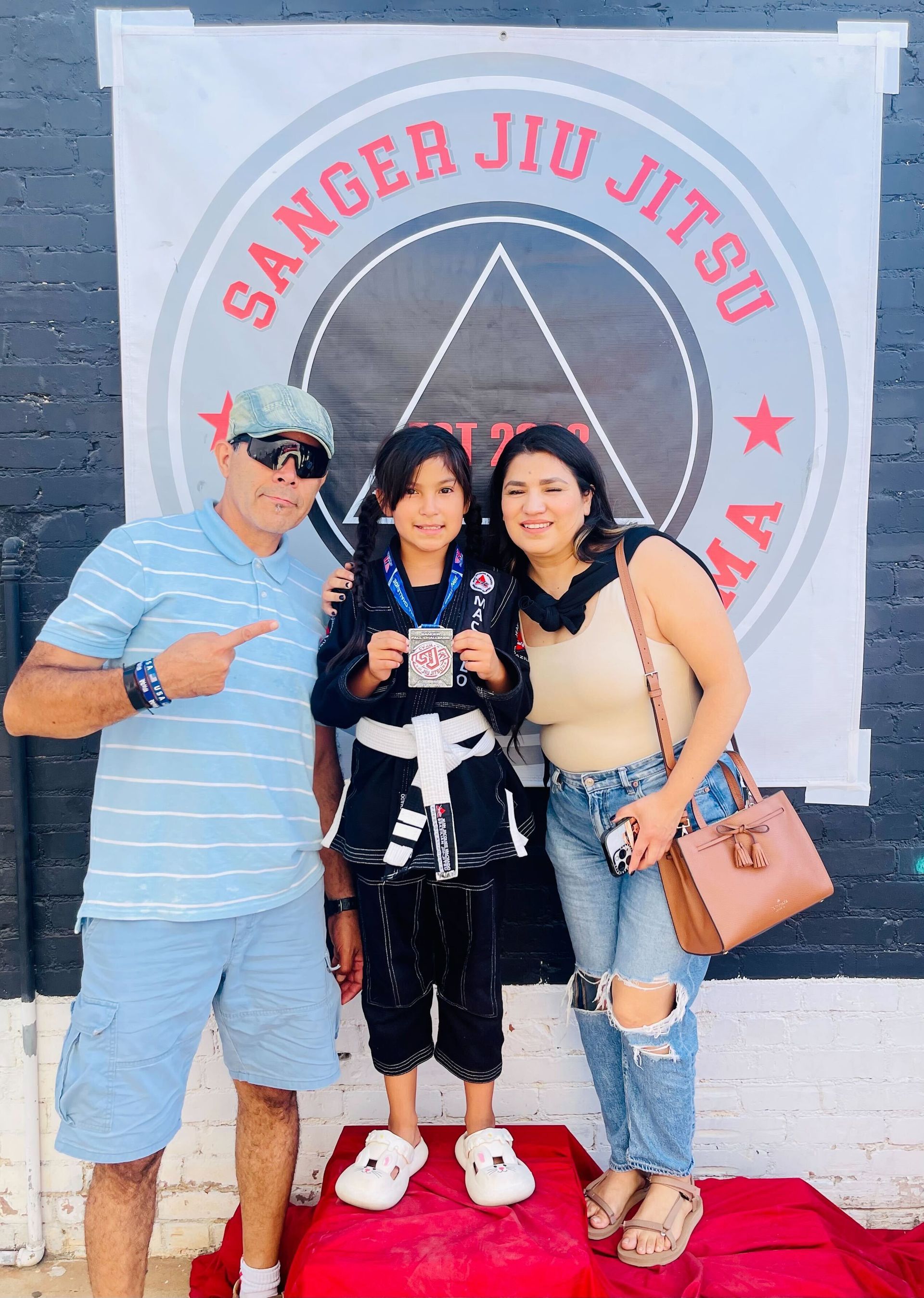 Families practicing martial arts techniques together at Jean Jacques Machado Fresno.
