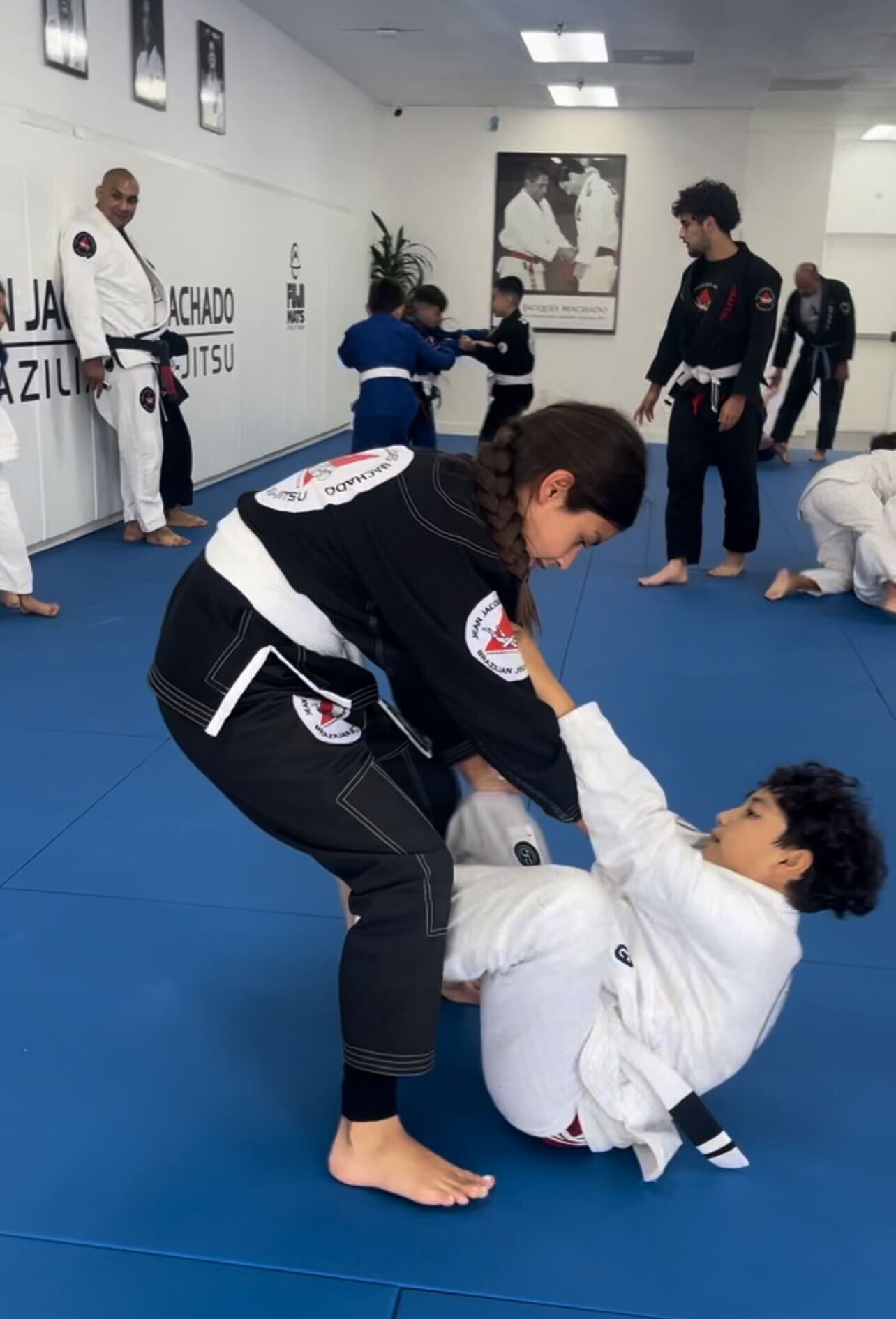 Adults drilling Brazilian Jiu-Jitsu at Jean Jacques Machado Fresno in Fresno, CA, building focus.