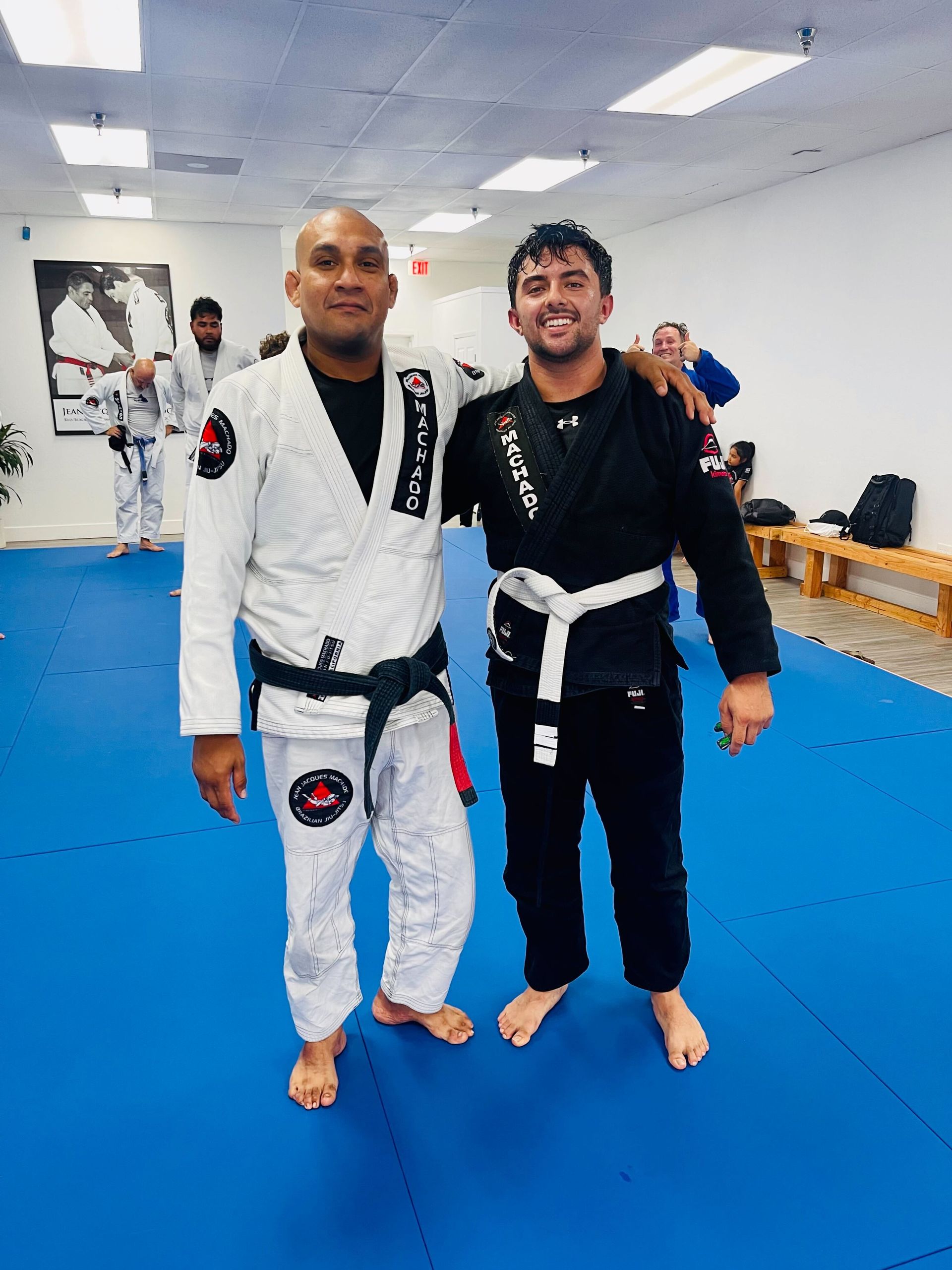 Students practicing Brazilian Jiu-Jitsu techniques during martial arts classes.