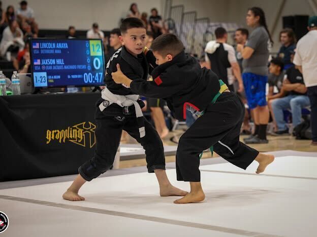 Students drilling Brazilian Jiu-Jitsu at Jean Jacques Machado Jiu-Jitsu Fresno in Fresno, CA to build fitness and confidence