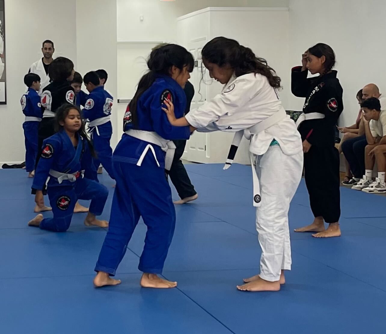 Kids practice safe self-defense grappling at Jean Jacques Machado Jiu-Jitsu Fresno in Fresno, CA, building confidence.