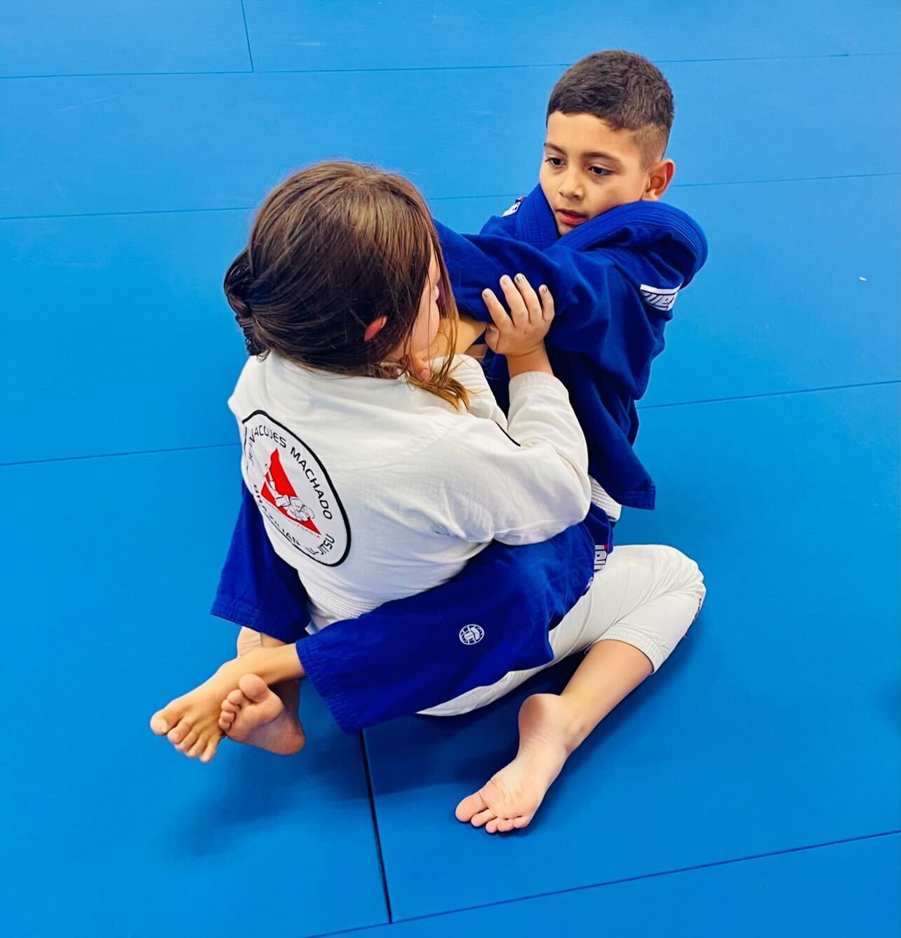 Kids practice controlled Brazilian Jiu-Jitsu drills at Jean Jacques Machado Jiu-Jitsu Fresno in Fresno, CA, building confidence.