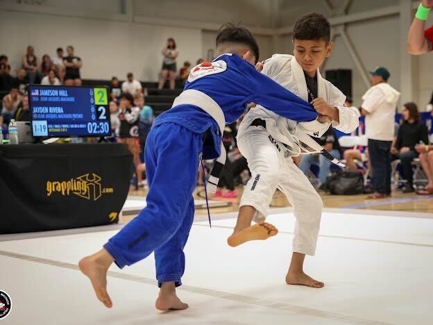 Kids practicing Brazilian Jiu Jitsu at Jean Jacques Machado Fresno, learning perseverance.