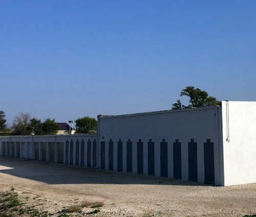 A white building with black stripes on the side of it
