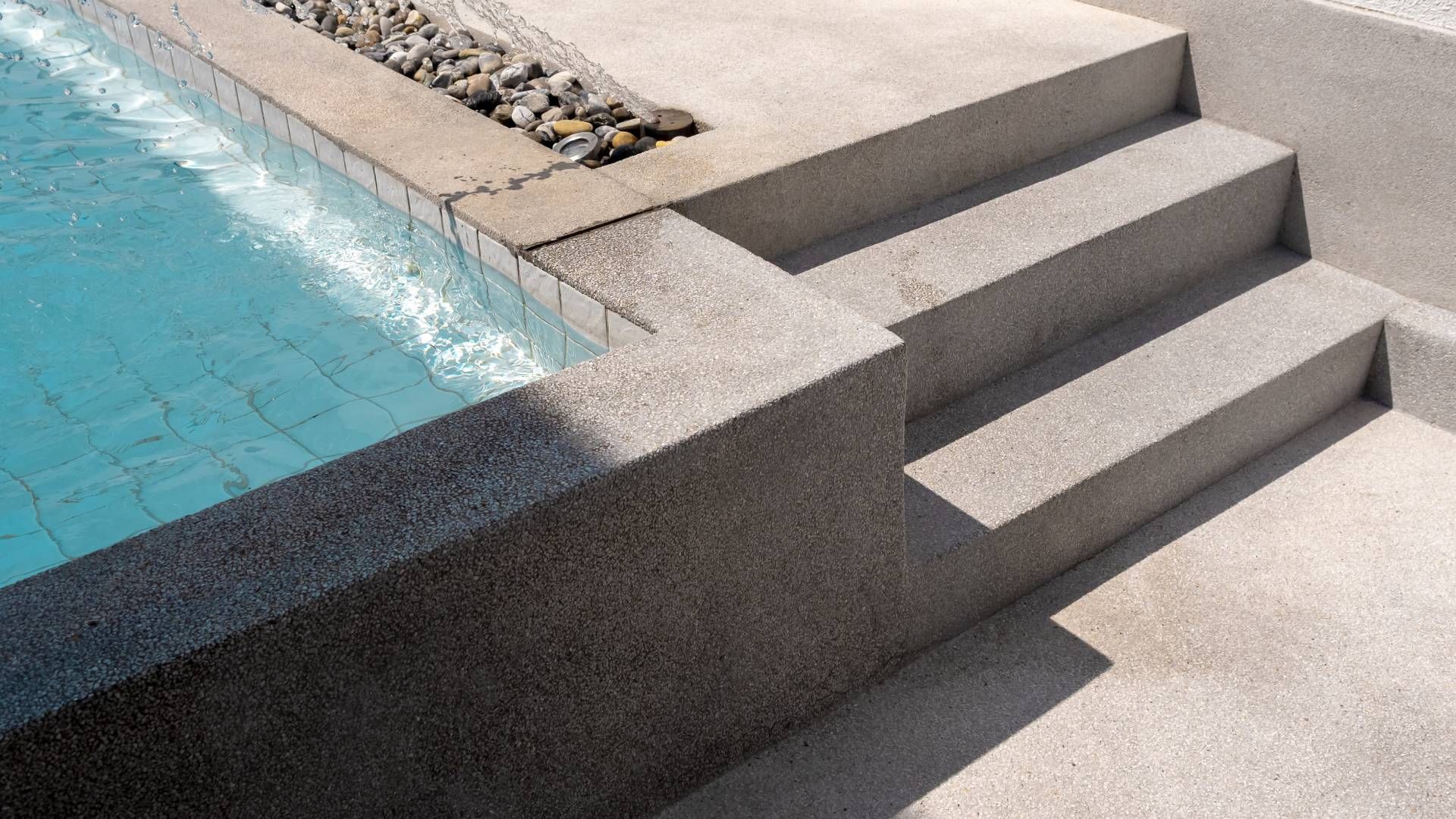 A swimming pool with stairs leading up to it.
