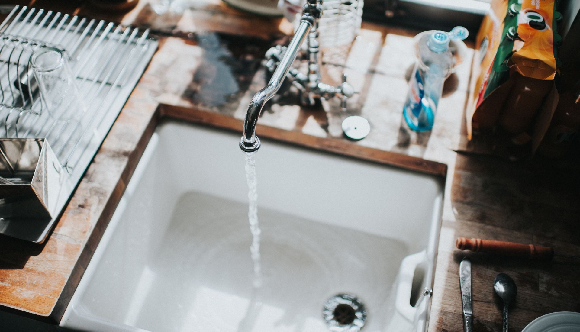 Kitchen Sink with Water Running from the Faucet — Scotts Valley, CA — George Allen & Sons Inc. Plumbing