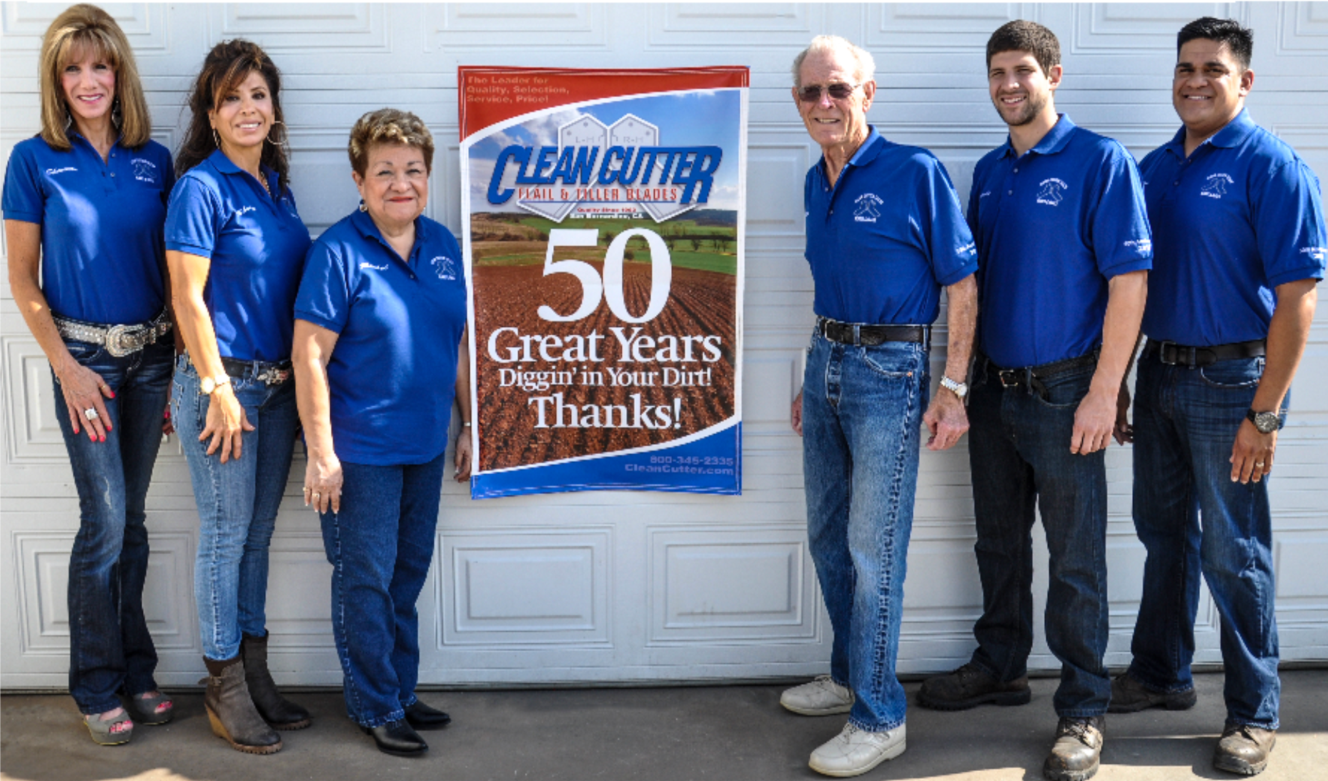 a group of people standing in front of a clean cutter sign