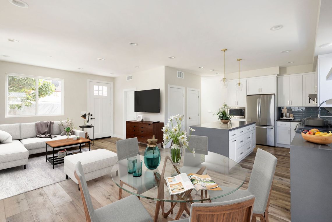 The interior of a 1200 square foot, three-bedroom, two story accessory dwelling unit (ADU) in Los Angeles, CA, featuring an open floor plan for the living, kitchen and dining spaces. 