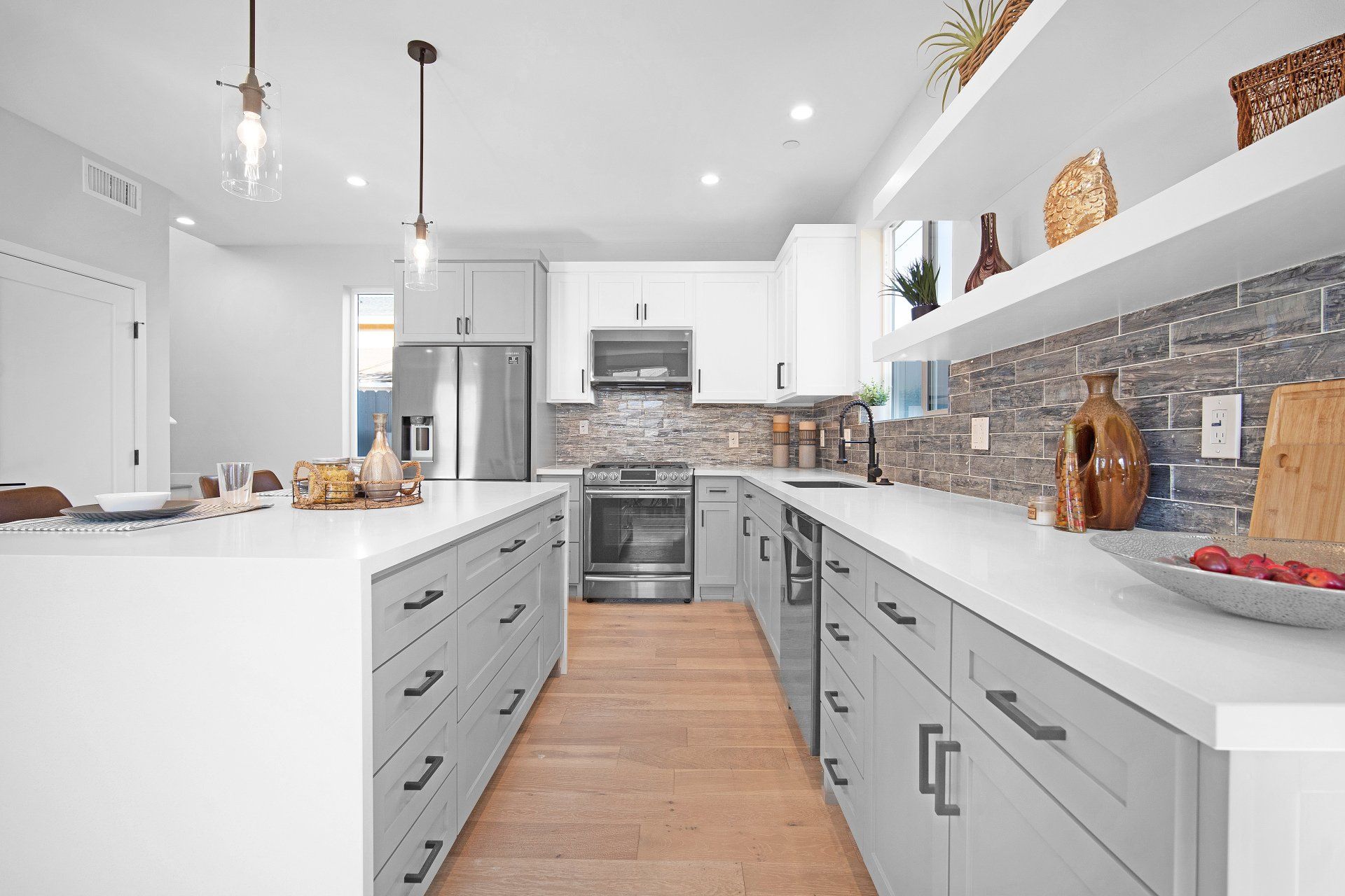 The full kitchen inside an accessory dwelling unit (ADU) backyard home, featuring plenty of space, an island, and modern all-electric appliances.