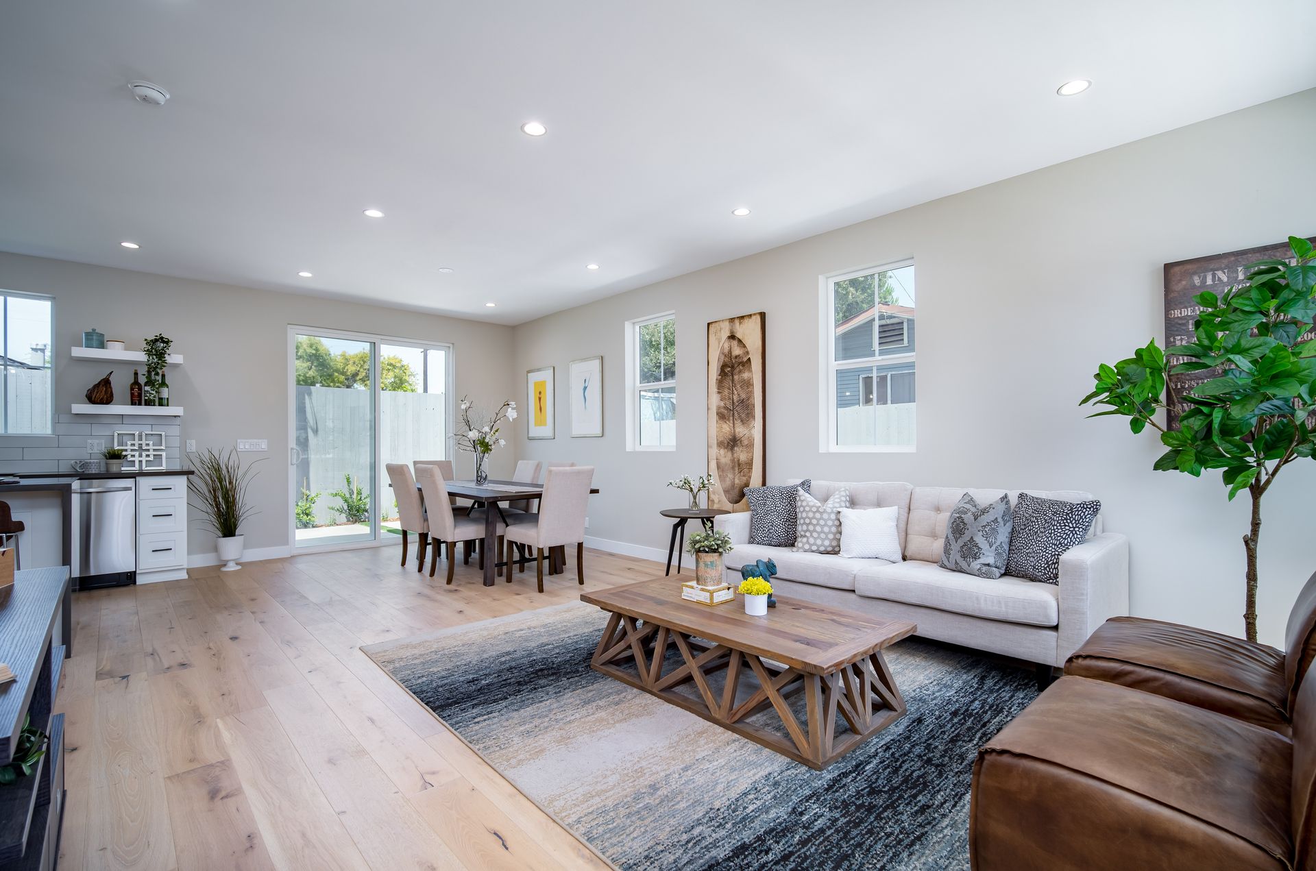 A spacious open floor plan looking at the living room and dining area from the kitchen of a 1200 square foot, three-bedroom, two story accessory dwelling unit (ADU) backyard home built in Los Angeles, CA.