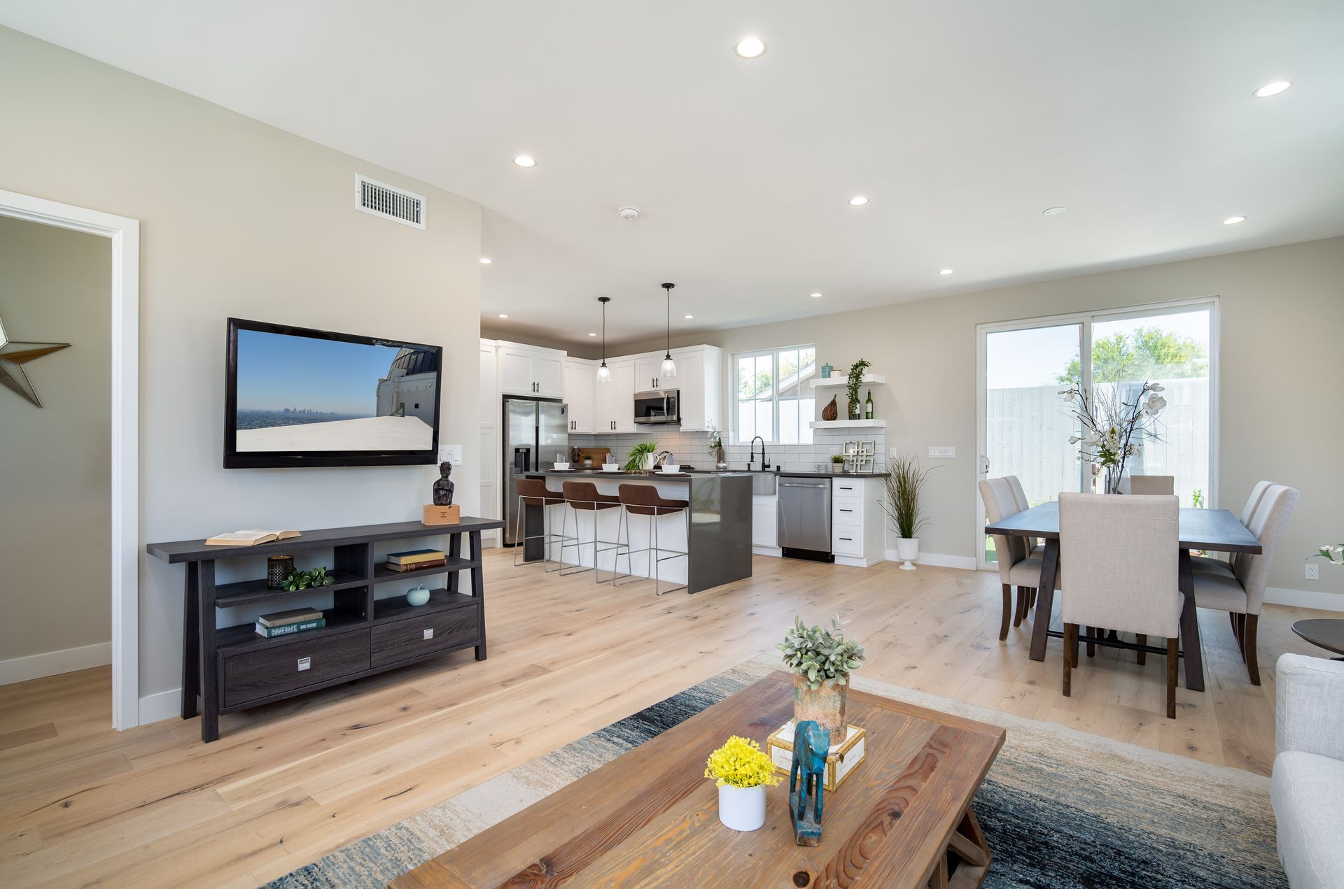 The interior of a 1200 square foot, three-bedroom, two story accessory dwelling unit (ADU) in Los Angeles, CA, featuring an open floor plan for the living, kitchen and dining spaces. 