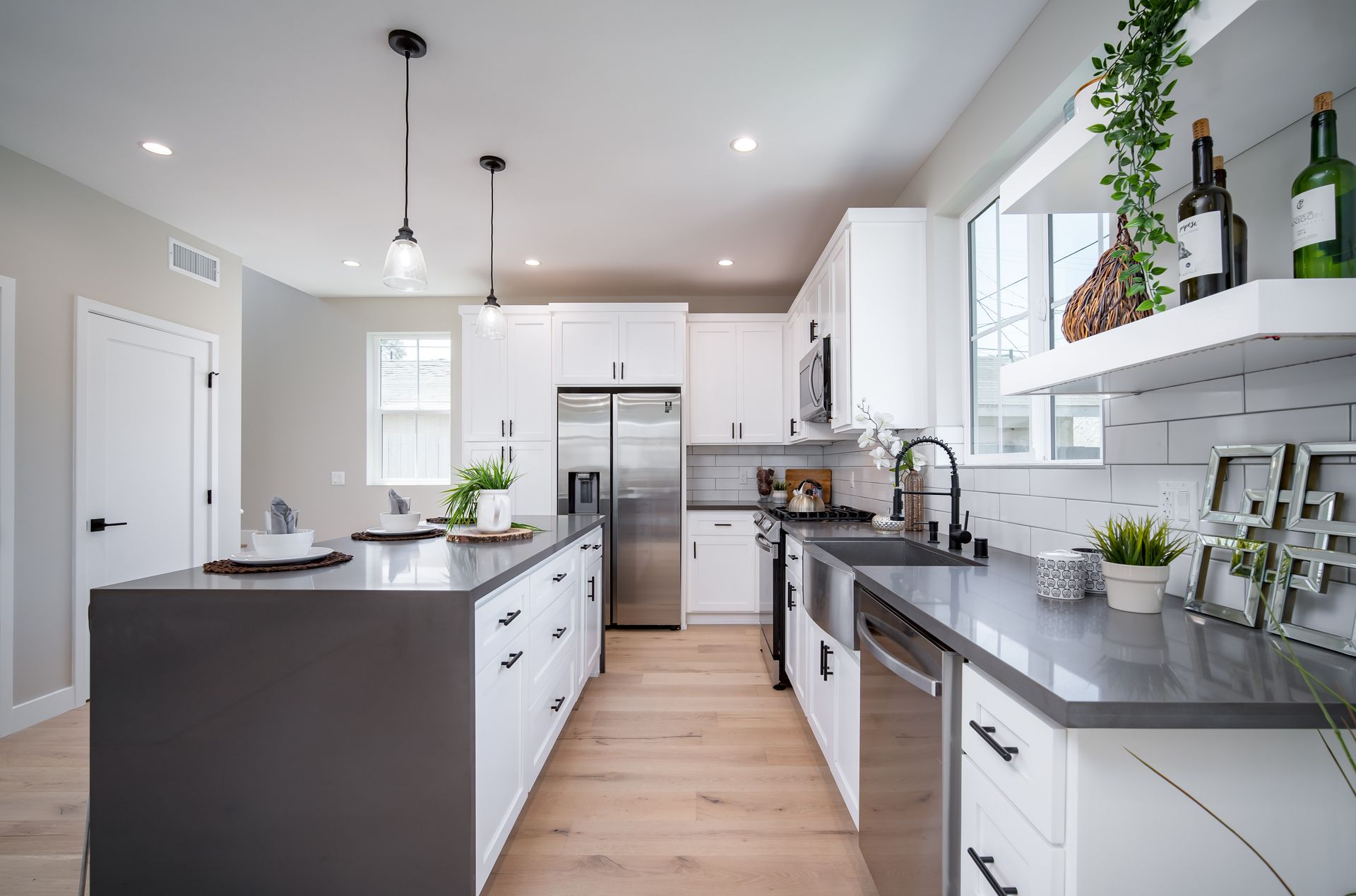 The full kitchen inside a 1200 square foot, three-bedroom, two story accessory dwelling unit (ADU) in Los Angeles, CA featuring plenty of space, an island, and modern all-electric appliances.