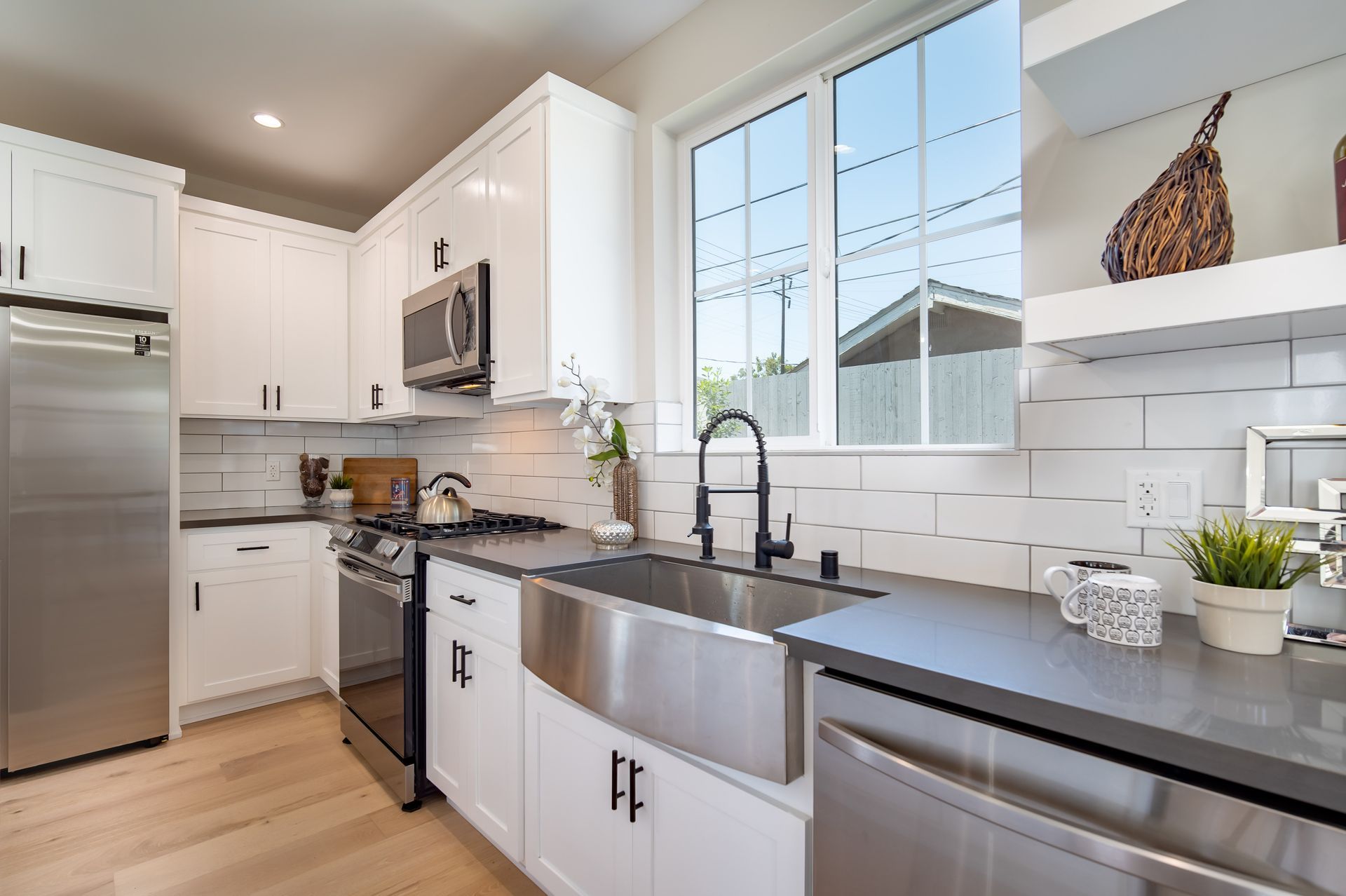 A bright and sunny kitchen with shiny new appliances in an accessory dwelling unit (ADU) granny flat.