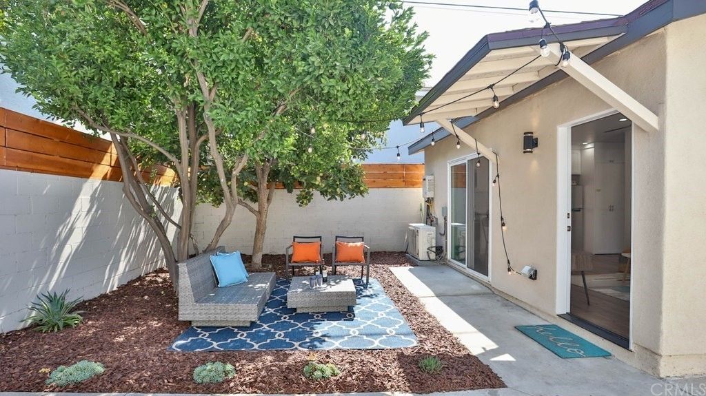 Reclaimed side yard converted into quaint outdoor patio for accessory dwelling unit (ADU) backyard home.
