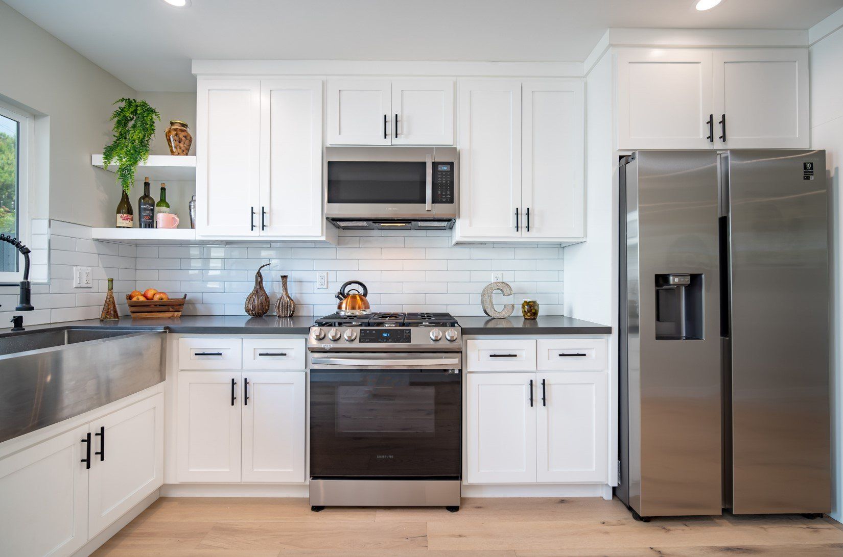 The full kitchen inside an accessory dwelling unit (ADU) backyard home, featuring modern all-electric appliances.