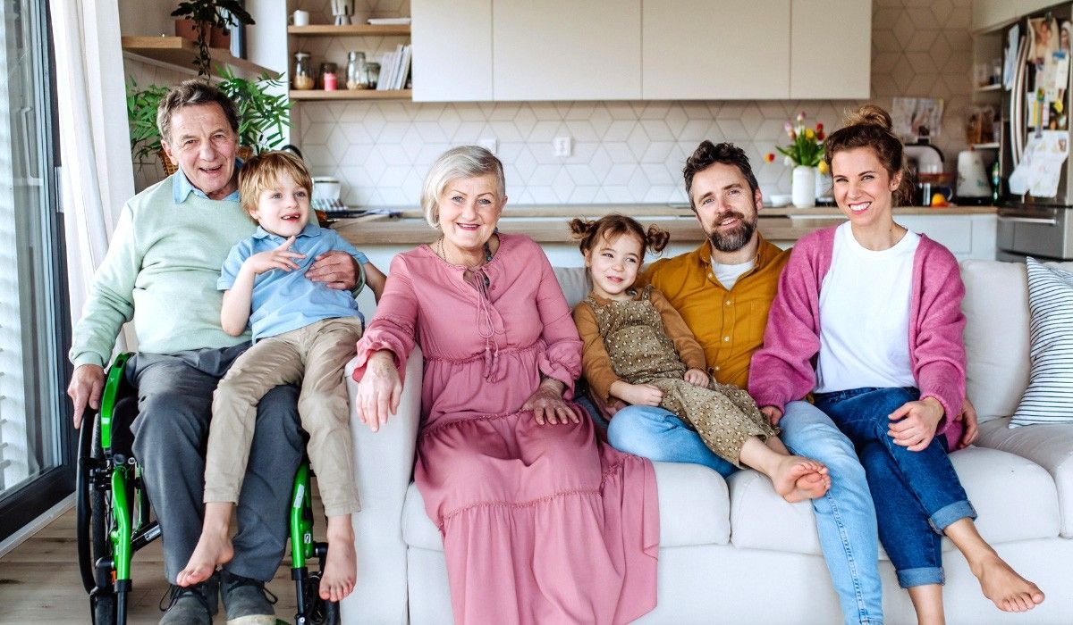 A family posing for a picture in their newly constructed accessory dwelling unit (ADU) backyard home