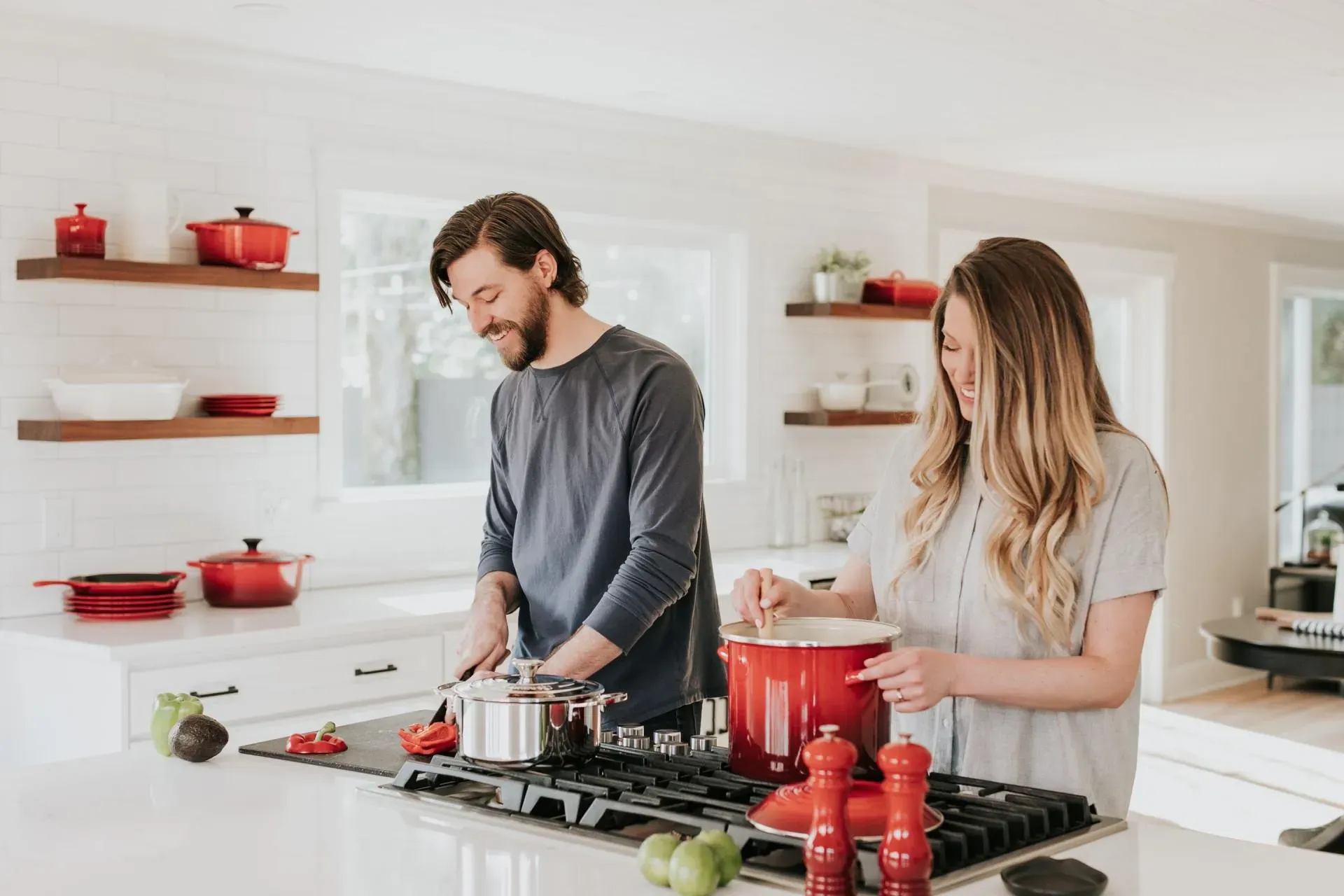 A young couple cooking together in the kitchen of their ADU casita