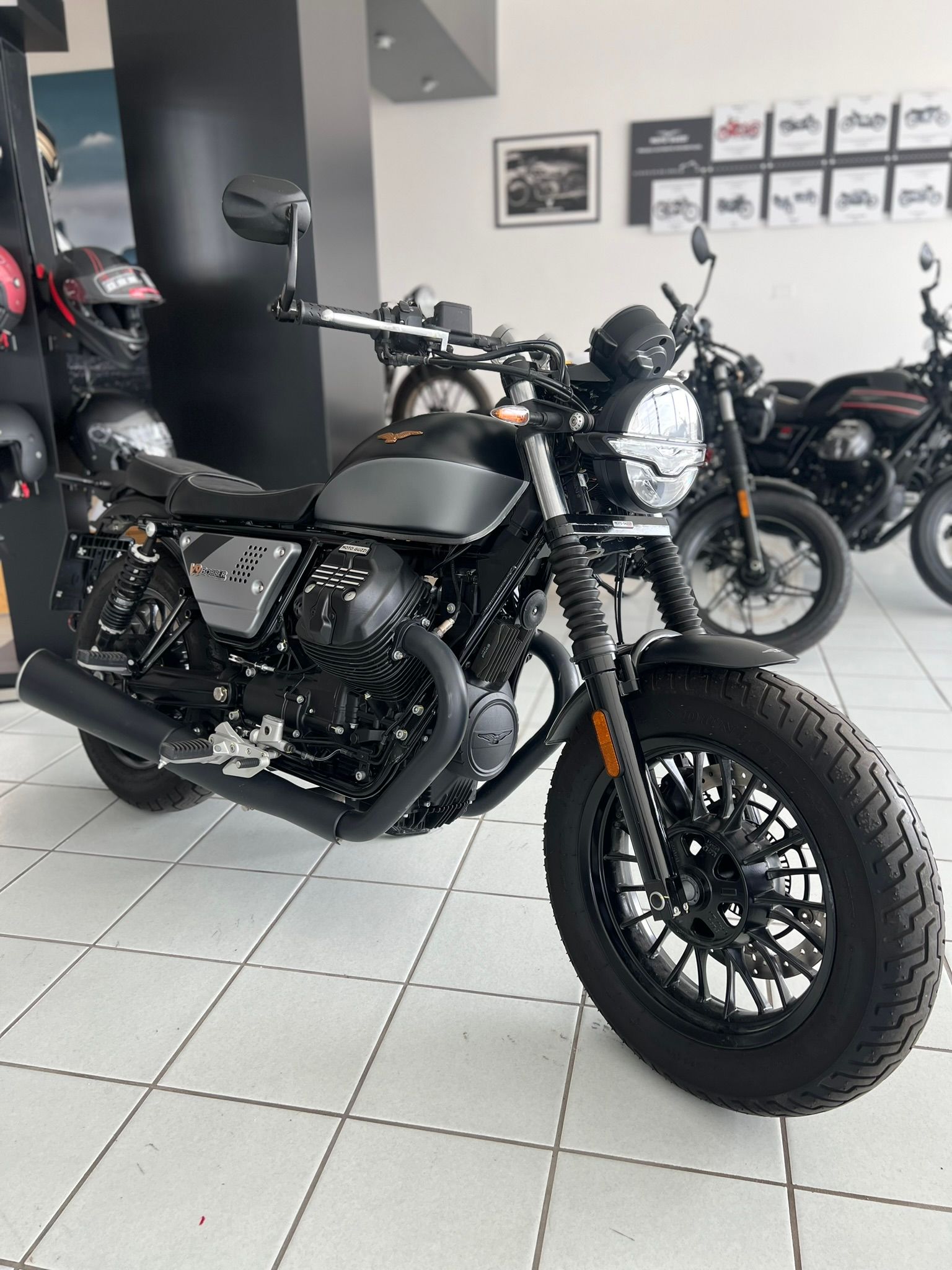 Una moto nera è parcheggiata in uno showroom.
