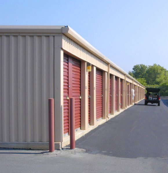 A row of storage units with red doors