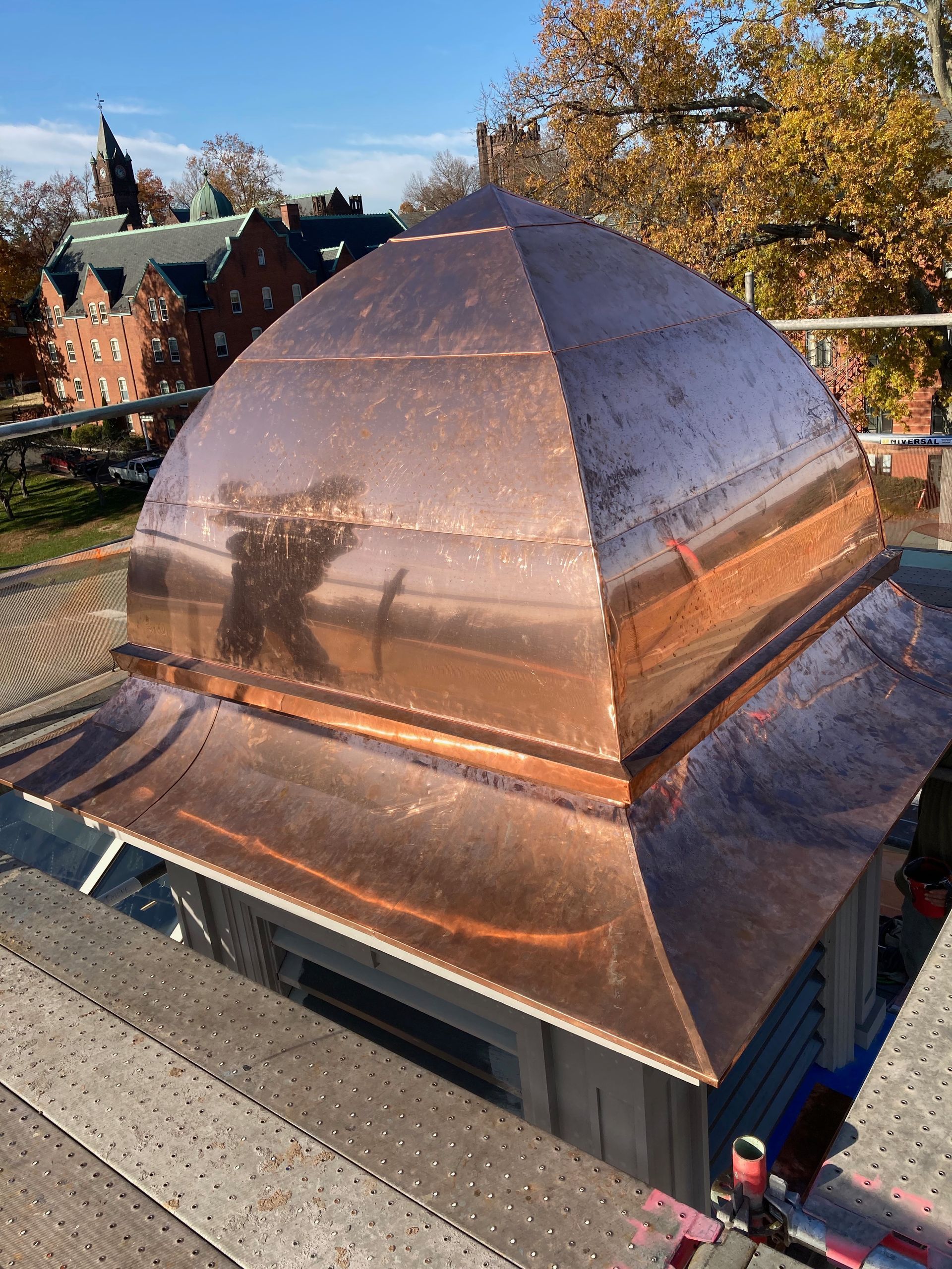 A large copper dome is sitting on top of a building.