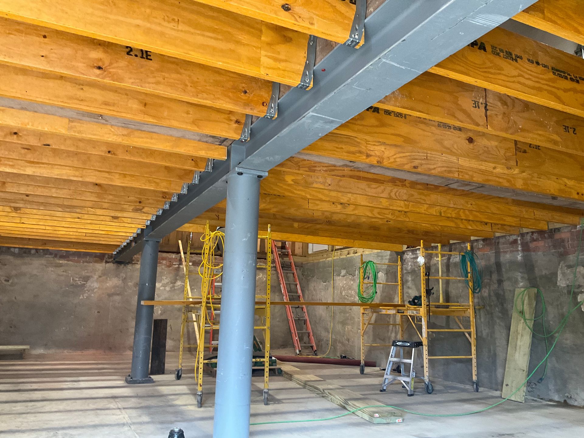 A building under construction with wooden beams and scaffolding.