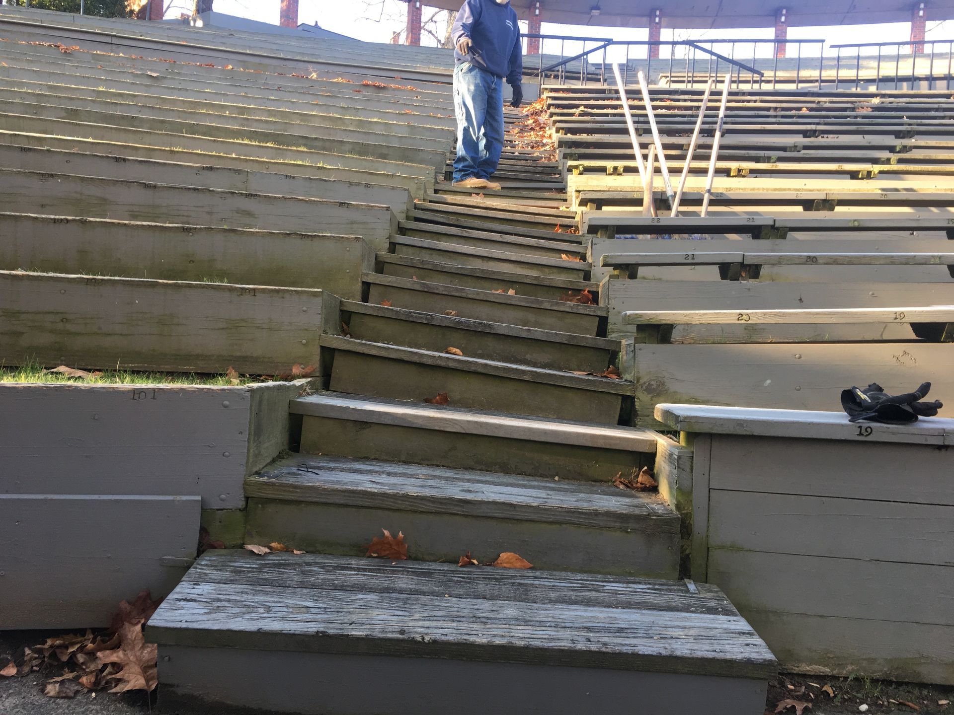 A man is walking up a set of wooden stairs