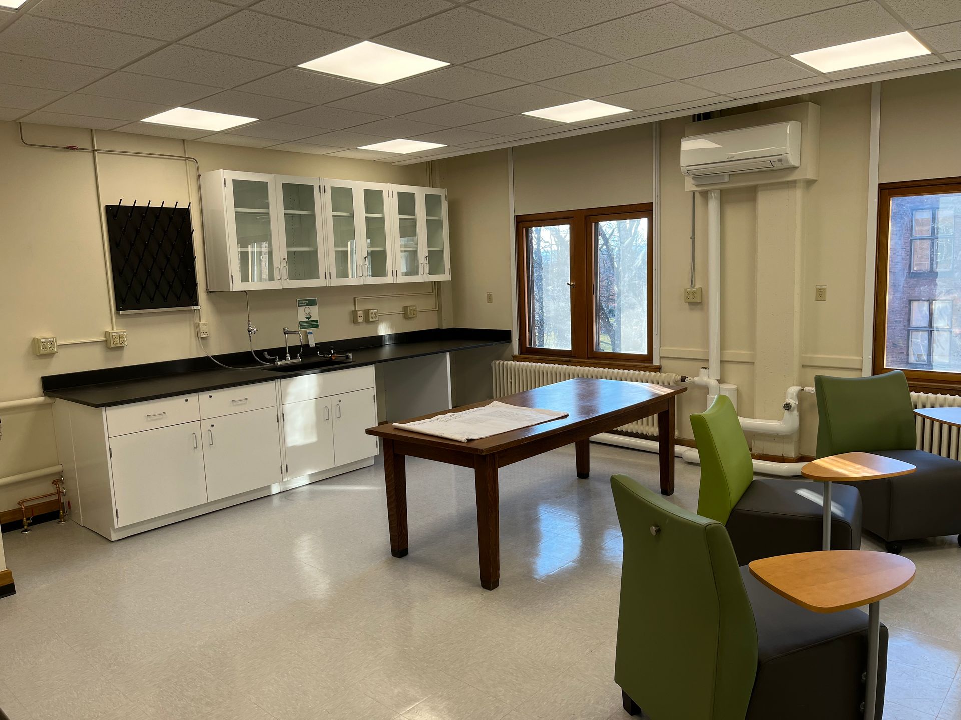 A large room with a table and chairs in it