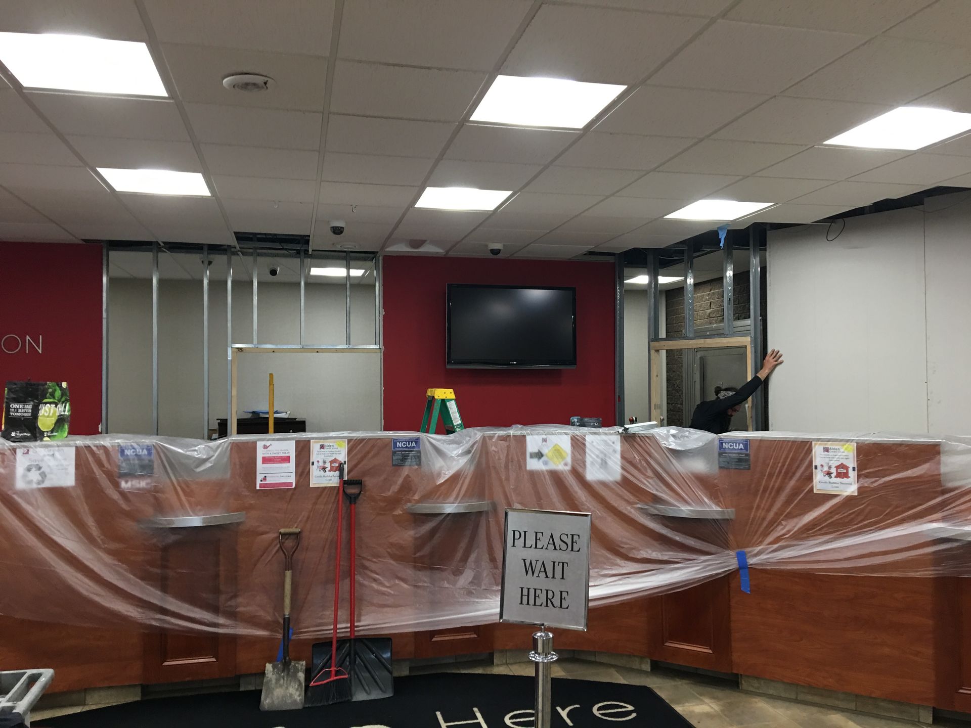 A bank is being remodeled and covered in plastic.