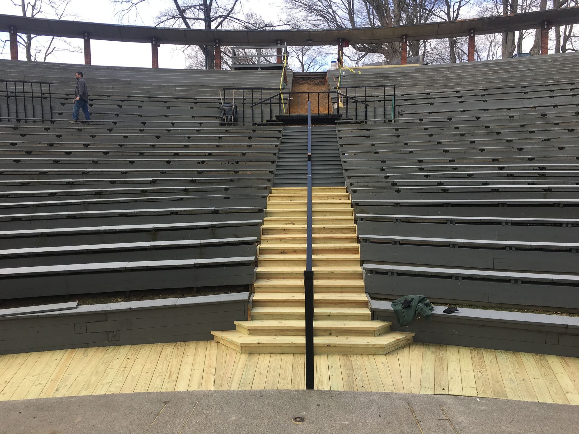 An empty amphitheater with wooden stairs leading up to it