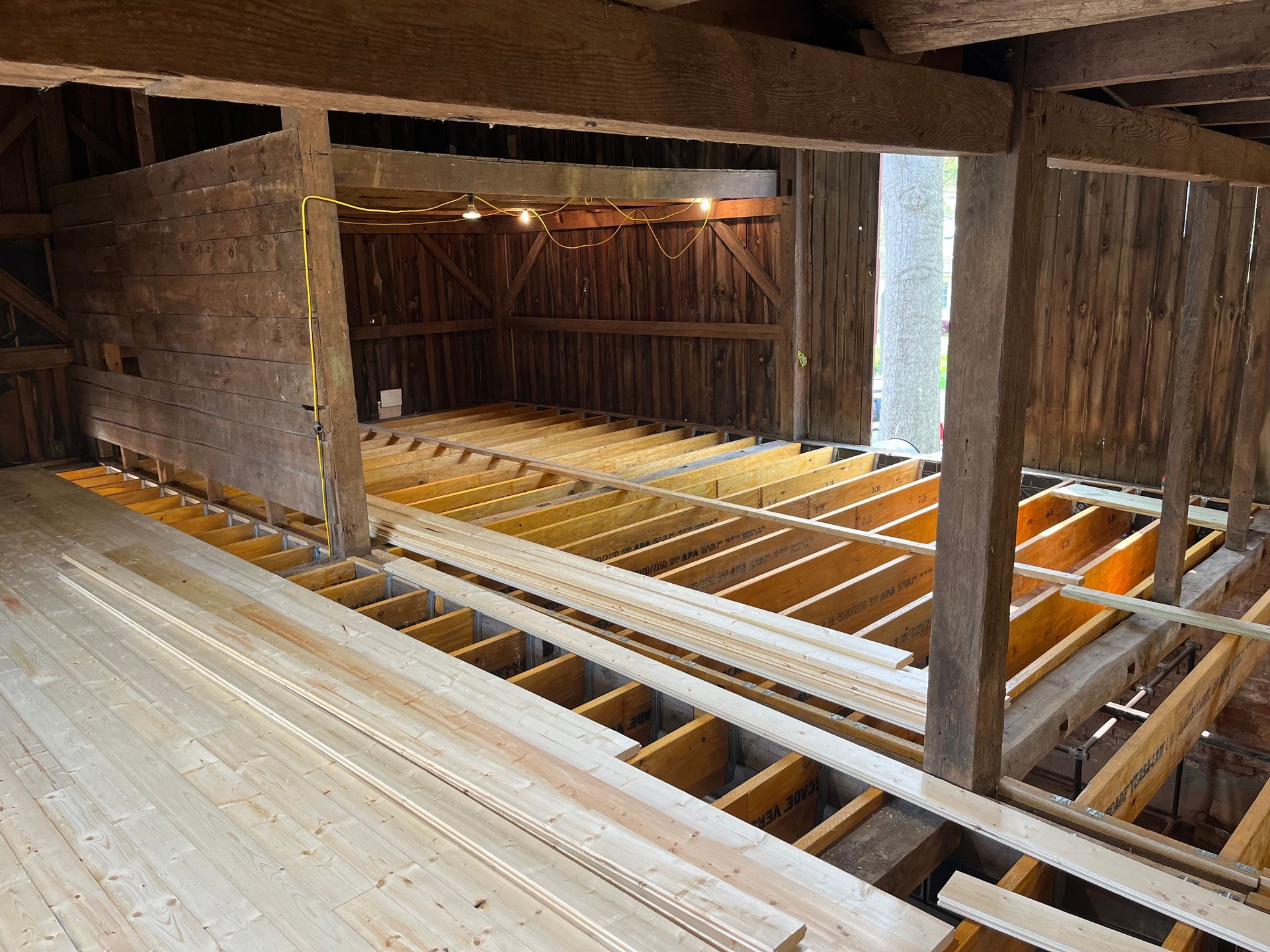 A wooden floor is being built in a barn.