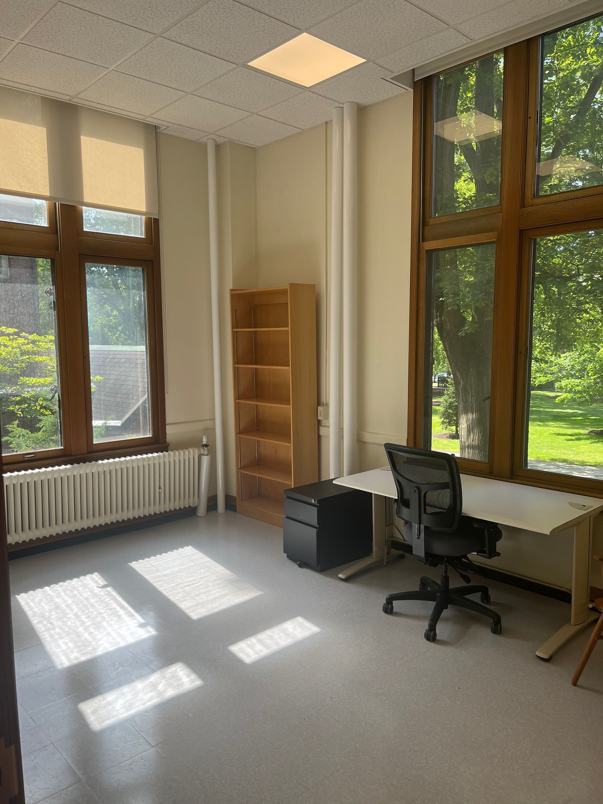 A room with a desk and a chair in it