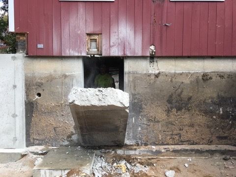 A red building with a hole in the side of it