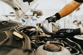 Technician Pouring Engine Oil During Service | EASE Auto Service