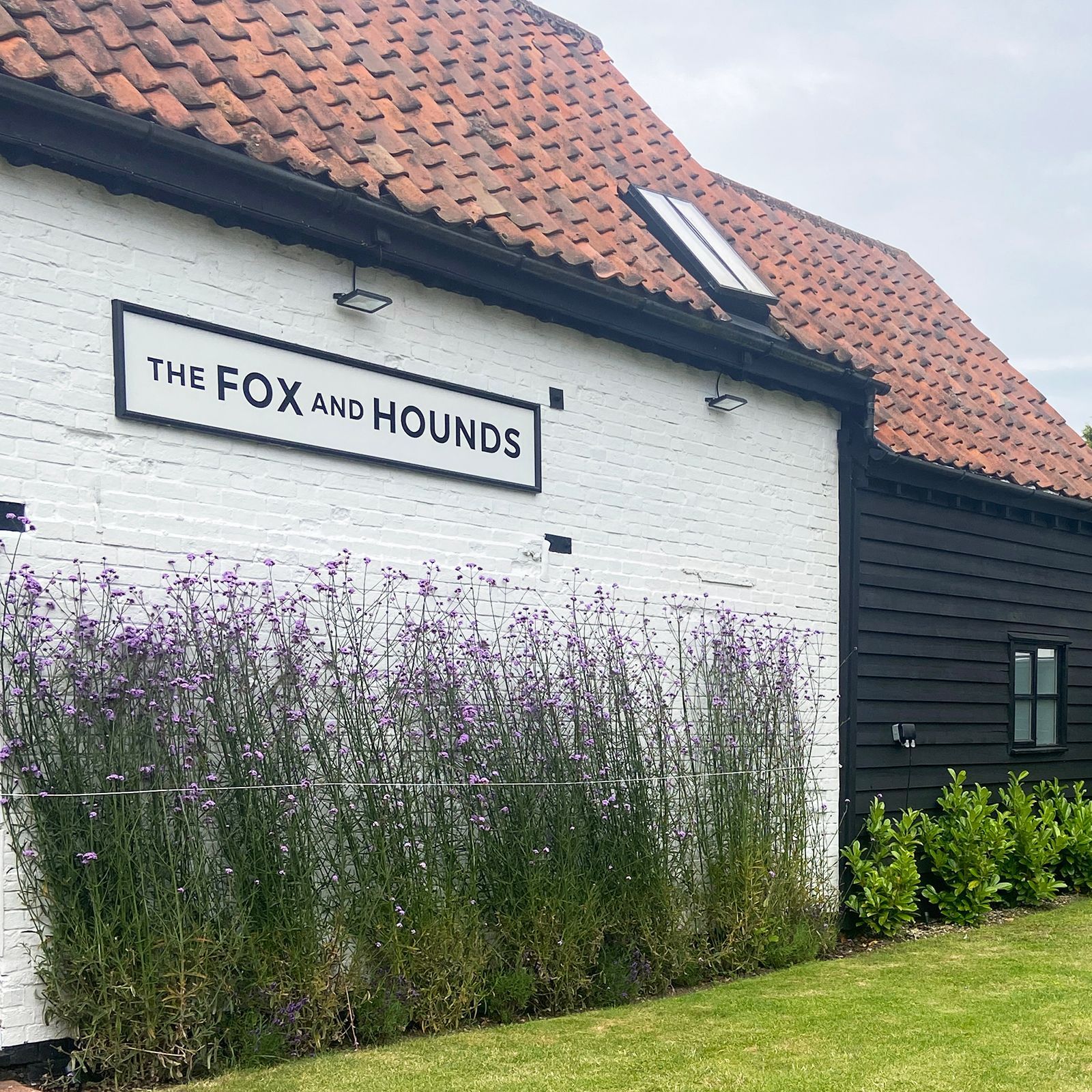 The Fox and Hounds front of barns with flowers 
