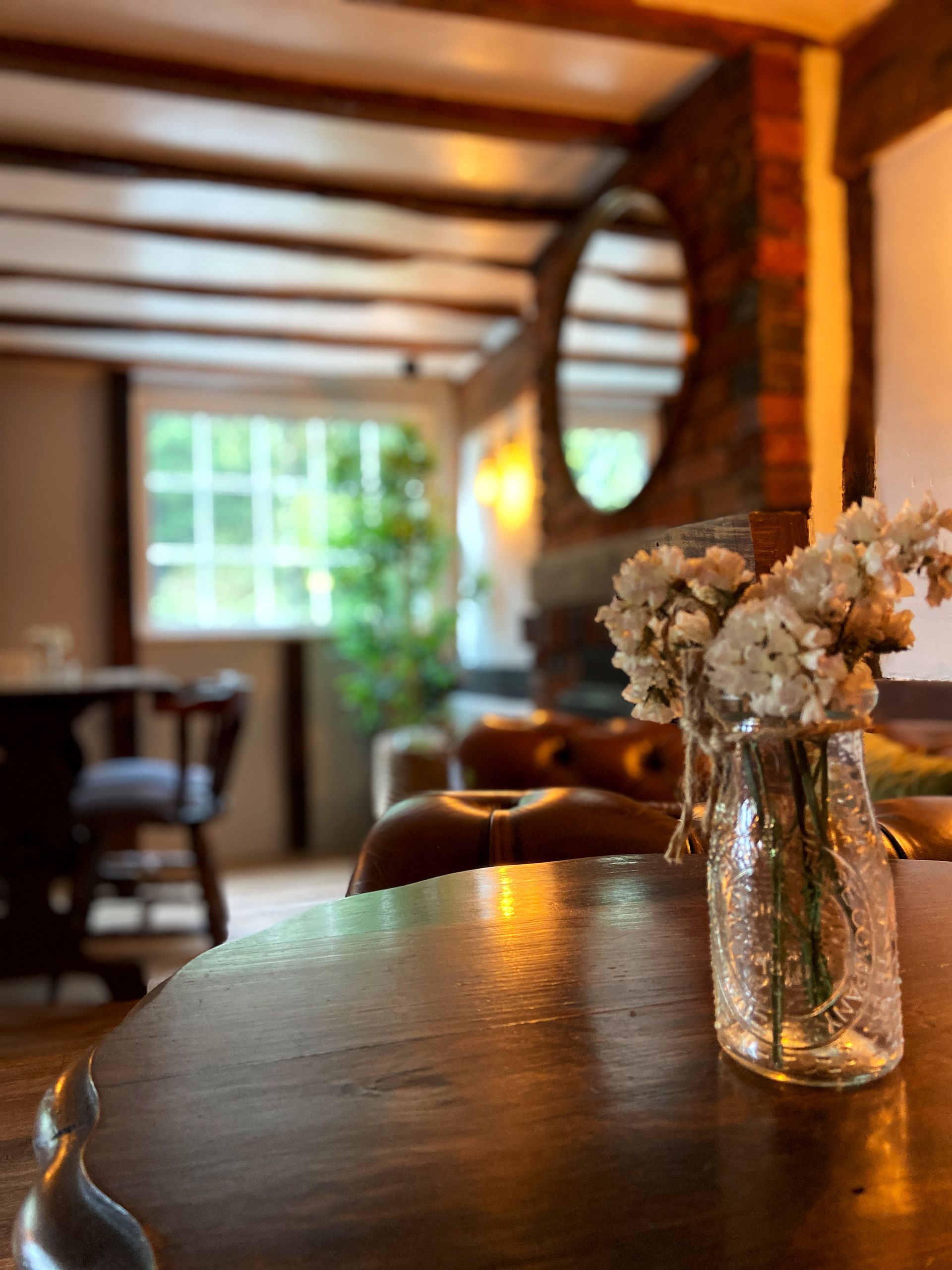 Inside the The Fox and Hounds with flowers on the table