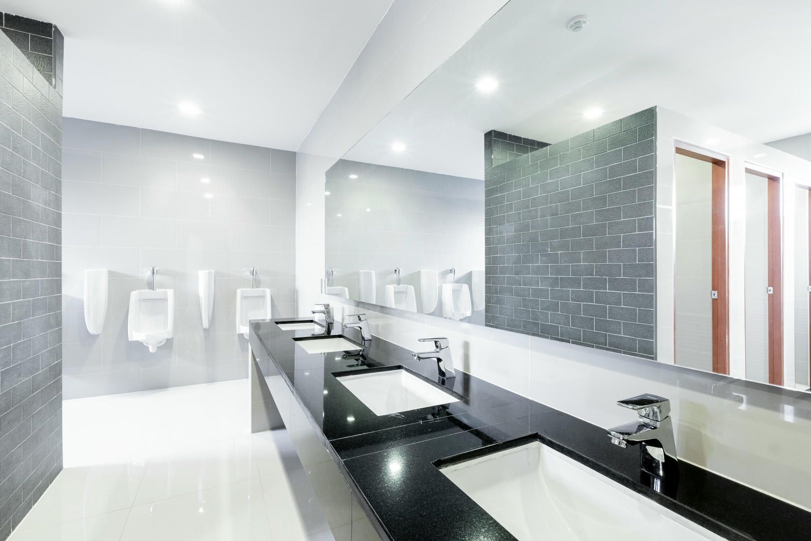 A bathroom with a lot of sinks and mirrors.