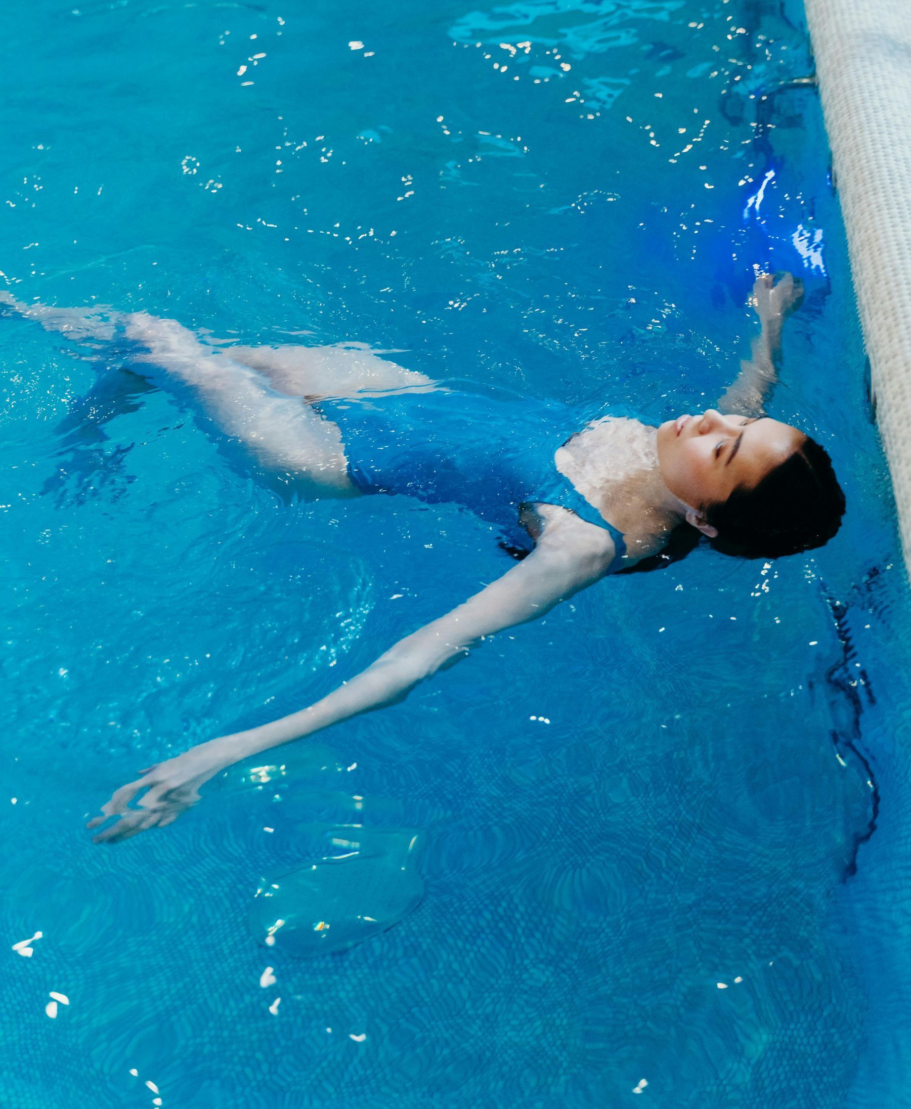 woman floating in pool