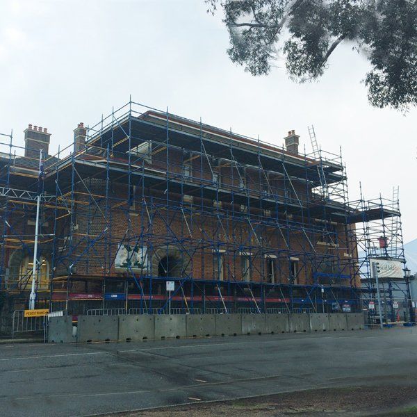 A large brick building with scaffolding around it.