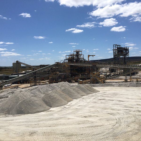 A large pile of dirt is in the middle of a construction site.