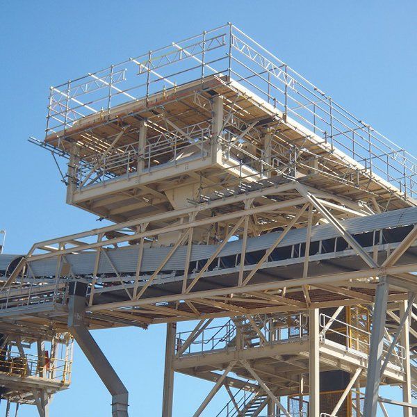 A large metal structure with a blue sky in the background