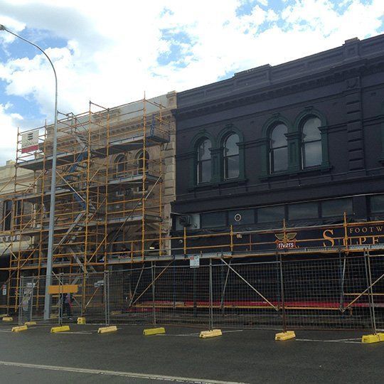 A building under construction with scaffolding on the side of it