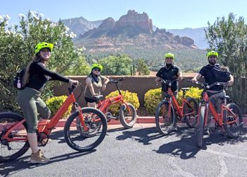 A group of people are riding bicycles on a road.