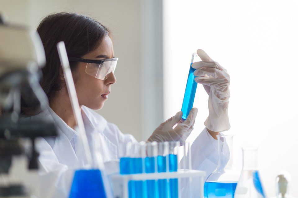 woman testing a liquid in a lab