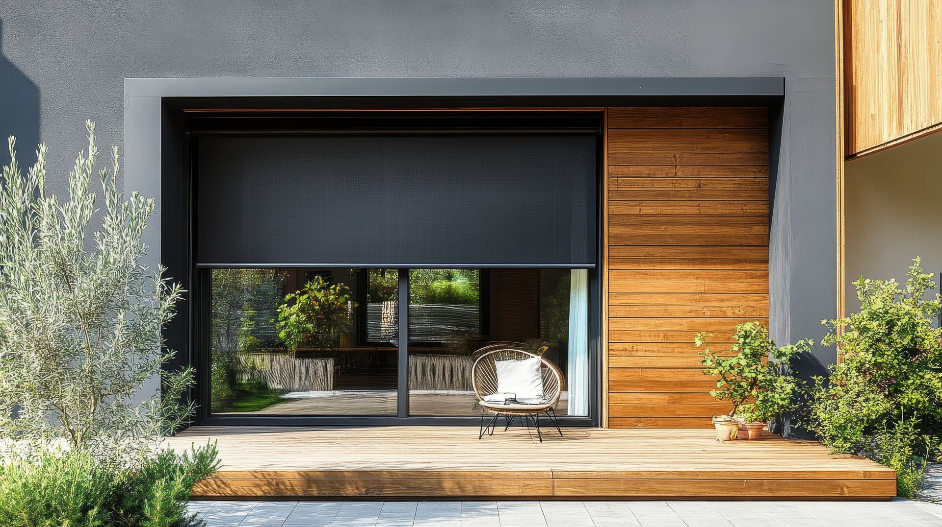 Modern house facade with large glass opening, wood siding, and a small patio garden