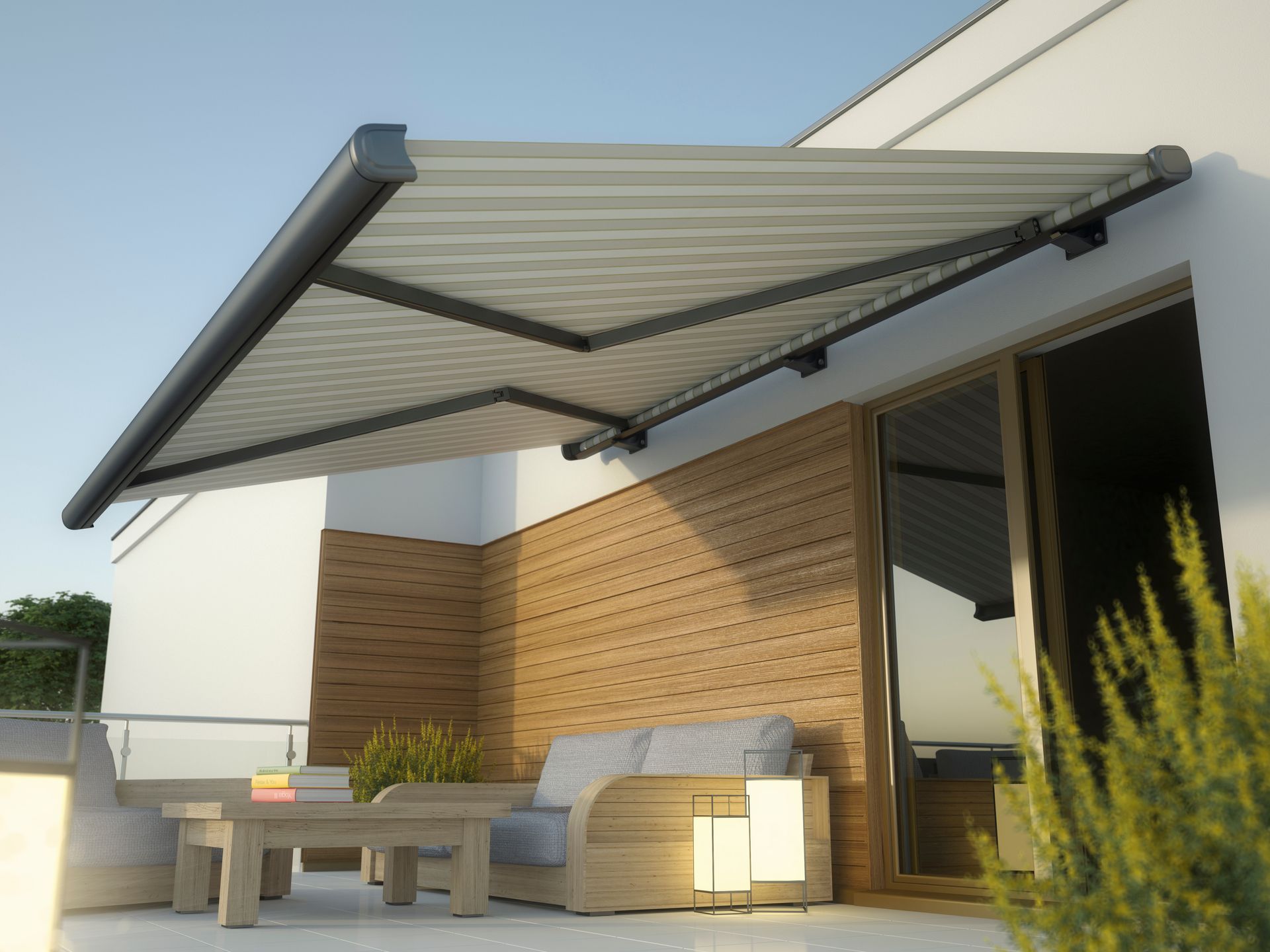 Modern patio with a retractable awning, outdoor sofa, and table beside a house