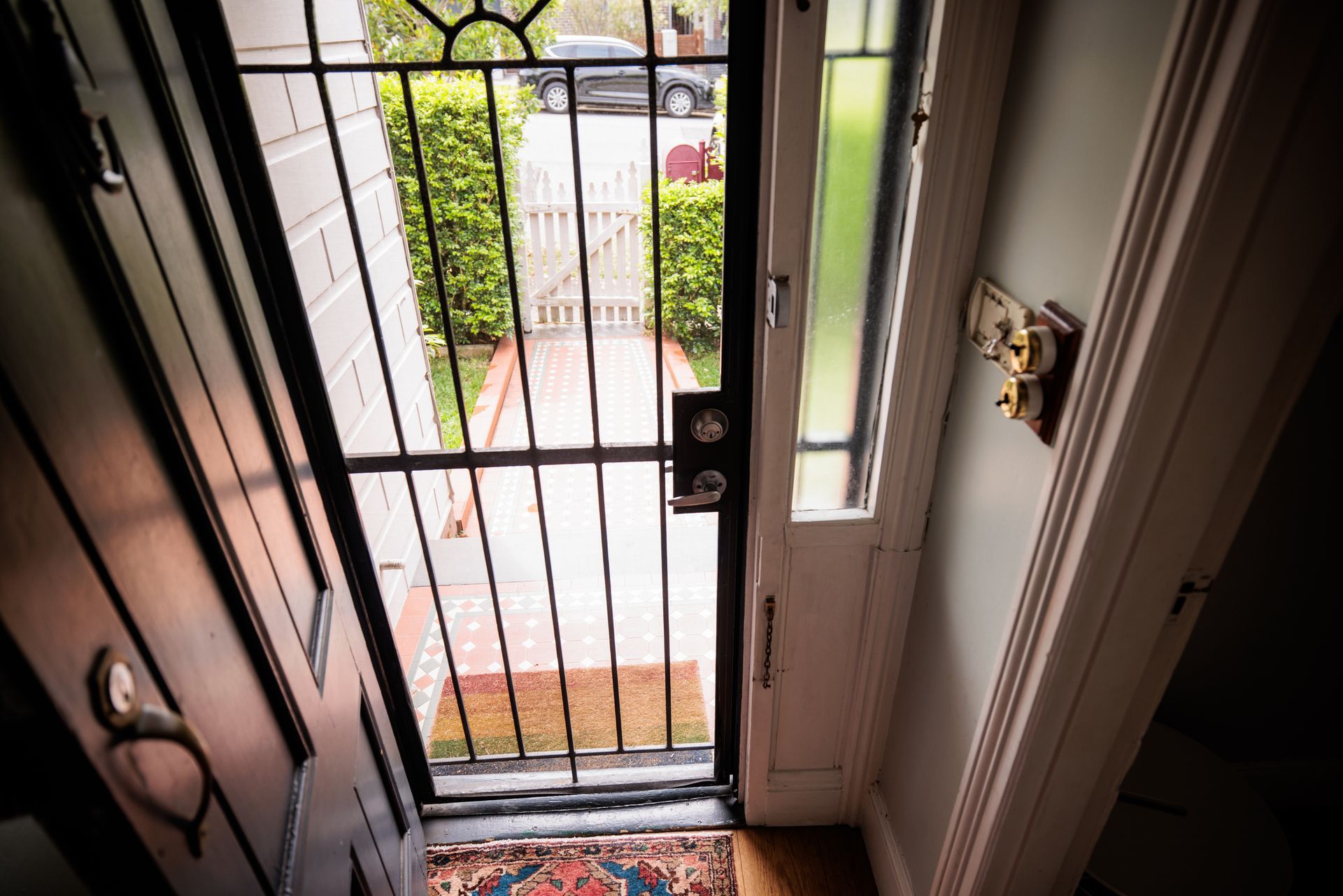 View of a security screen door in a house, looking from inside.