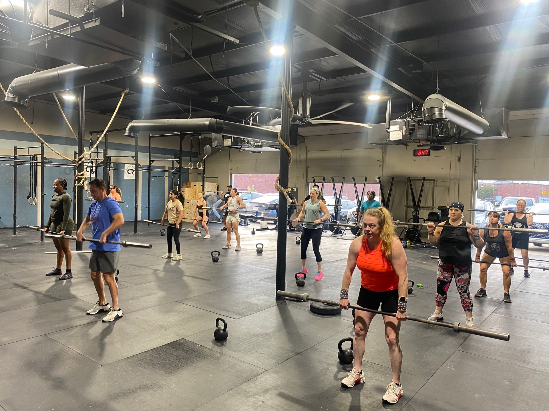 A group of people are doing exercises in a gym.