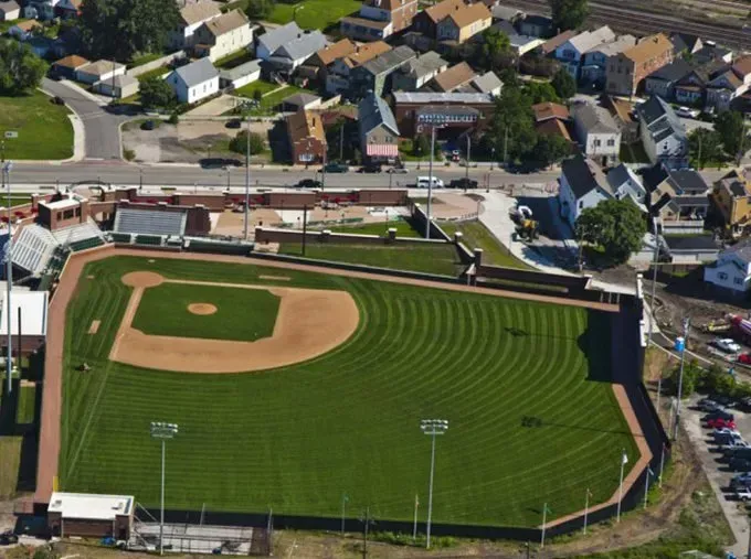 An aerial view of a baseball field in a residential area
